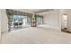 Large living room with sliding doors to the pool area at 4412 Lake In The Woods Dr, Spring Hill, FL 34607