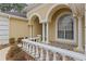 Elegant porch with arched entryway and tile flooring at 4412 Lake In The Woods Dr, Spring Hill, FL 34607