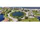Aerial view of waterfront community with circular road and pond at 4424 Floramar Ter, New Port Richey, FL 34652