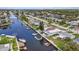 Wide aerial showcasing home, canal, and neighborhood at 4424 Floramar Ter, New Port Richey, FL 34652