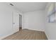 Simple bedroom with light walls and wood-look floors at 4424 Floramar Ter, New Port Richey, FL 34652