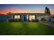 Charming single story home with a blue door and well-manicured lawn at 4424 Floramar Ter, New Port Richey, FL 34652