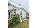 Side view of the house with landscaping at 4424 Floramar Ter, New Port Richey, FL 34652