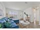 Living room with a blue sectional, wood floors, and a view to the outside at 4424 Floramar Ter, New Port Richey, FL 34652