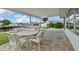 Covered patio with outdoor dining set and water views at 4424 Floramar Ter, New Port Richey, FL 34652