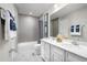 Clean bathroom with double vanity, tub, and gray tile at 4515 Spire Run, Lakewood Ranch, FL 34211