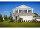 Two-story house with a neutral color scheme, landscaping, and a two-car garage at 4515 Spire Run, Lakewood Ranch, FL 34211