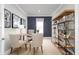 Home office with a large desk, two chairs, and a tall wooden bookshelf at 4515 Spire Run, Lakewood Ranch, FL 34211
