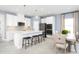 Modern kitchen with white cabinets, large island, and stainless steel appliances at 4515 Spire Run, Lakewood Ranch, FL 34211