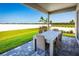 Covered patio with table and chairs, overlooking backyard at 4515 Spire Run, Lakewood Ranch, FL 34211