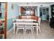 Dining room with farmhouse table and chairs, kitchen partially visible at 4620 Bay Blvd # 1145, Port Richey, FL 34668