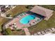Community pool with patio furniture and covered seating area at 4620 Bay Blvd # 1145, Port Richey, FL 34668