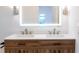 Modern bathroom with double vanity, quartz countertop, and LED lit mirror at 4852 Capron St, New Port Richey, FL 34653