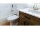 Updated bathroom with wood vanity, white sink, and modern toilet at 4852 Capron St, New Port Richey, FL 34653