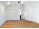 Spacious bedroom with wood floors, large closet, and en-suite bathroom at 4852 Capron St, New Port Richey, FL 34653