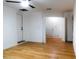 Bedroom with wood flooring and access to laundry and storage at 4852 Capron St, New Port Richey, FL 34653