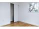 Bright bedroom with wood floors, white walls, and a closet at 4852 Capron St, New Port Richey, FL 34653