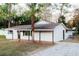 Newly renovated single story home with a gravel driveway and mature landscaping at 4852 Capron St, New Port Richey, FL 34653