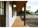 Covered walkway with a modern light fixture, leading to the home's entrance at 4852 Capron St, New Port Richey, FL 34653