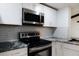 Stainless steel range, microwave and granite countertops at 4852 Capron St, New Port Richey, FL 34653