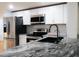 Modern kitchen with stainless steel appliances and granite countertops at 4852 Capron St, New Port Richey, FL 34653