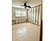 Unfinished bathroom with tile flooring, walls and window at 4907 Floramar Ter, New Port Richey, FL 34652