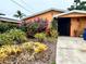 Landscaped front yard with colorful flowers and plants at 4907 Floramar Ter, New Port Richey, FL 34652