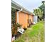 Side yard view showing exterior wall, landscaping, and shed at 4907 Floramar Ter, New Port Richey, FL 34652