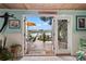 Sunroom with water views, built-in seating, and access to patio at 4907 Floramar Ter, New Port Richey, FL 34652