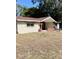 Tan single story home with brick entryway and walkway at 5641 Quist Dr, Port Richey, FL 34668