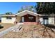Tan single story home with brick entryway and walkway at 5641 Quist Dr, Port Richey, FL 34668