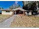 Tan single story home with brick entryway and walkway at 5641 Quist Dr, Port Richey, FL 34668