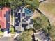 Aerial view showing home with solar panels, pool, and a neighborhood at 609 Salt Lake Dr, Tarpon Springs, FL 34689