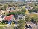 Aerial view of home with solar panels and a neighborhood near a lake at 609 Salt Lake Dr, Tarpon Springs, FL 34689