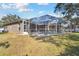 Large backyard with a screened pool and plenty of green space at 609 Salt Lake Dr, Tarpon Springs, FL 34689