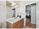 Bright bathroom with wood vanity, single sink and view of dining area at 609 Salt Lake Dr, Tarpon Springs, FL 34689