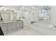 Spa-like bathroom featuring a soaking tub, walk-in shower, and double vanity at 609 Salt Lake Dr, Tarpon Springs, FL 34689