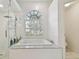 Relaxing bathroom with a large soaking tub and a walk-in shower at 609 Salt Lake Dr, Tarpon Springs, FL 34689