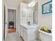 Guest bathroom with single sink vanity and toilet at 609 Salt Lake Dr, Tarpon Springs, FL 34689