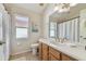 Clean bathroom with wood vanity, shower/tub combo and single sink at 609 Salt Lake Dr, Tarpon Springs, FL 34689