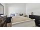 Well-lit bedroom with a double bed and dark dresser at 609 Salt Lake Dr, Tarpon Springs, FL 34689