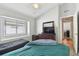 Bedroom with two twin beds, dresser, and en-suite bathroom at 609 Salt Lake Dr, Tarpon Springs, FL 34689