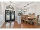 Bright dining room featuring a glass-top table and hardwood floors at 609 Salt Lake Dr, Tarpon Springs, FL 34689