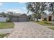 Home with three-car garage and patterned driveway at 609 Salt Lake Dr, Tarpon Springs, FL 34689