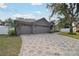 Home with three-car garage and geometric driveway at 609 Salt Lake Dr, Tarpon Springs, FL 34689