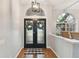 Inviting entryway with double doors, hardwood floors, and decorative wreaths at 609 Salt Lake Dr, Tarpon Springs, FL 34689