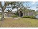Gray house with double doors and lush landscaping at 609 Salt Lake Dr, Tarpon Springs, FL 34689