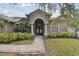 Gray house with double doors and walkway at 609 Salt Lake Dr, Tarpon Springs, FL 34689