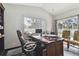 Bright home office with a large desk and two chairs at 609 Salt Lake Dr, Tarpon Springs, FL 34689