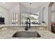 Kitchen with granite countertop, black sink, and pool view at 609 Salt Lake Dr, Tarpon Springs, FL 34689